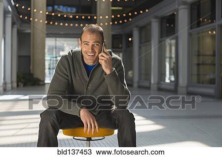 Stock Image - Caucasian man talking on cell phone. Fotosearch