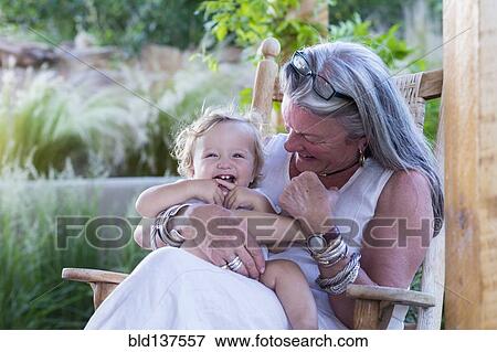 Caucasian older woman holding grandson in rocking chair View Large Photo Image Stock Photo - Caucasian older woman holding grandson in rocking chair. Fotosearch