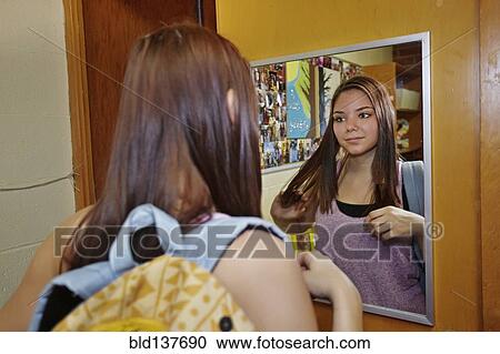 Caucasian student brushing hair in dorm room View Large Photo Image Stock Image - Caucasian student brushing hair in dorm room. Fotosearch