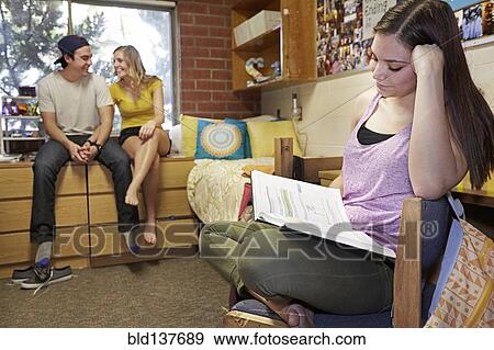 Stock Photo - Caucasian student reading in dorm room. Fotosearch