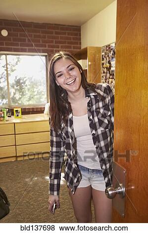 Stock Photo - Caucasian student smiling in dorm room. Fotosearch