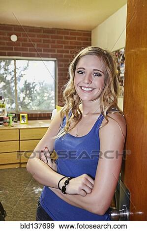 Stock Photo - Caucasian student smiling in dorm room. Fotosearch