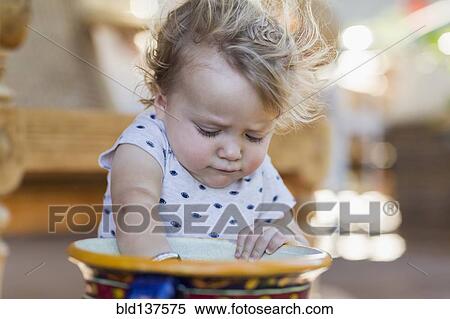 Caucasian toddler digging in bucket View Large Photo Image Stock Photography - Caucasian toddler digging in bucket. Fotosearch