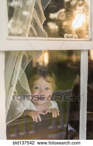 Caucasian toddler looking out window View Large Photo Image Stock Image - Caucasian toddler looking out window. Fotosearch
