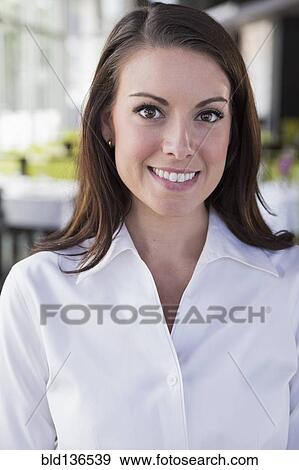 Caucasian waitress smiling in restaurant View Large Photo Image Stock Photo - Caucasian waitress smiling in restaurant. Fotosearch