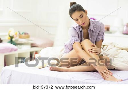 Caucasian woman applying moisturizer to leg View Large Photo Image Stock Image - Caucasian woman applying moisturizer to leg. Fotosearch