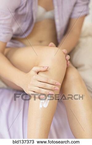 Caucasian woman applying moisturizer to leg View Large Photo Image Stock Image - Caucasian woman applying moisturizer to leg. Fotosearch
