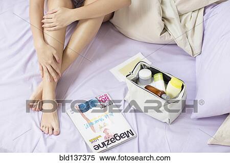 Caucasian woman applying moisturizer to leg View Large Photo Image Stock Photography - Caucasian woman applying moisturizer to leg. Fotosearch