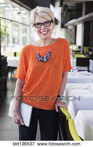 Caucasian woman smiling in restaurant View Large Photo Image Stock Photo - Caucasian woman smiling in restaurant. Fotosearch