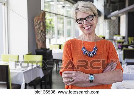 Stock Photograph - Caucasian woman smiling in restaurant. Fotosearch