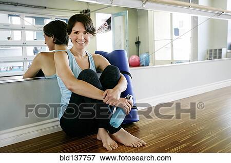 Stock Photo - Caucasian woman smiling in yoga studio. Fotosearch