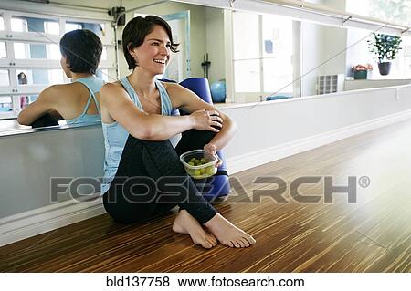 Stock Photo - Caucasian woman smiling in yoga studio. Fotosearch