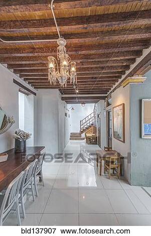 Stock Photo - Chandelier and benches in modern hallway. Fotosearch