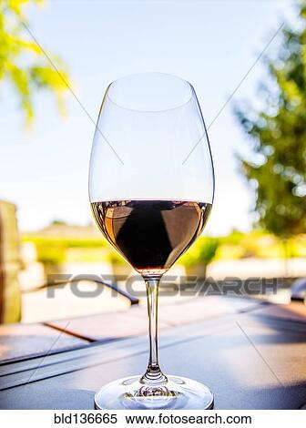 Stock Photography - Close up of glass of wine on table. Fotosearch