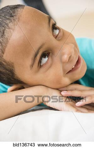 Stock Image - Close up of mixed race boy smiling. Fotosearch