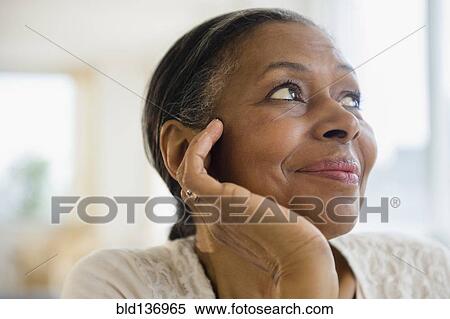 Close up of mixed race woman resting chin in hand View Large Photo Image Stock Photography - Close up of mixed race woman resting chin in hand. Fotosearch
