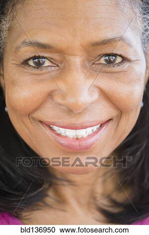 Stock Image - Close up of mixed race woman smiling. Fotosearch