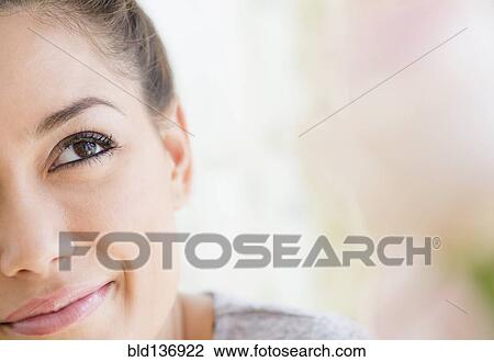 Stock Image - Close up of woman looking up. Fotosearch