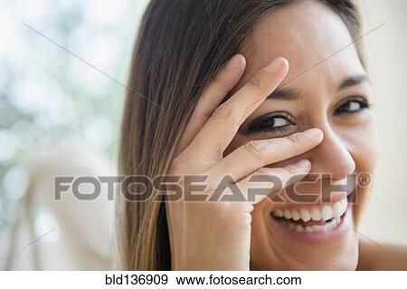 Close up of woman peering through fingers View Large Photo Image Stock Photo - Close up of woman peering through fingers. Fotosearch