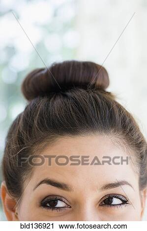 Close up of woman wearing a bun View Large Photo Image Stock Image - Close up of woman wearing a bun. Fotosearch