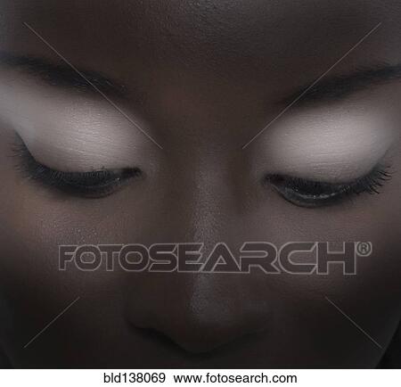Stock Photo - Close up of woman wearing eyeshadow. Fotosearch