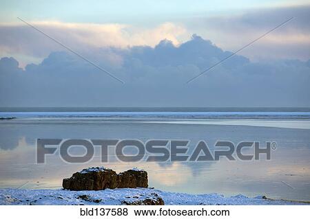 Clouds reflected in still ocean in arctic landscape View Large Photo Image Stock Photo - Clouds reflected in still ocean in arctic landscape. Fotosearch