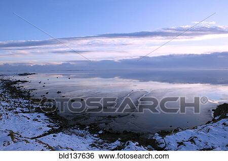 Clouds reflected in still ocean in arctic landscape View Large Photo Image Stock Photograph - Clouds reflected in still ocean in arctic landscape. Fotosearch