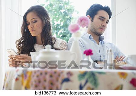 Stock Image - Couple arguing in restaurant. Fotosearch