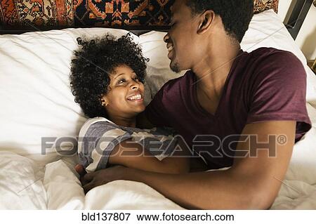 Stock Photo - Couple playing in bed. Fotosearch