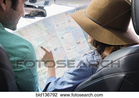 Couple reading map together View Large Photo Image Stock Image - Couple reading map together. Fotosearch