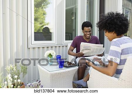 Couple relaxing together on porch View Large Photo Image Picture - Couple relaxing together on porch. Fotosearch