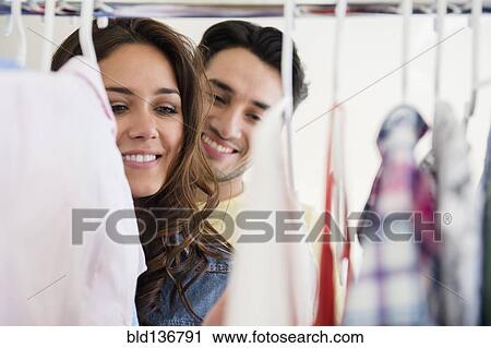 Stock Image - Couple shopping together in store. Fotosearch
