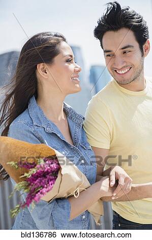Stock Photograph - Couple walking together on city street. Fotosearch