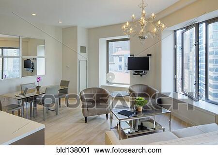 Stock Image - Dining table and armchairs in urban apartment. Fotosearch