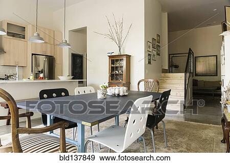 Stock Photo - Dining table and chairs in modern living space. Fotosearch