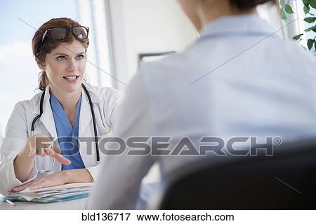 Stock Photo - Doctor and patient talking in office. Fotosearch