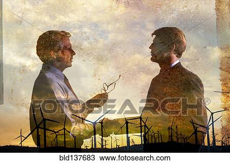 Stock Image - Double exposure of businessmen and wind turbines. Fotosearch
