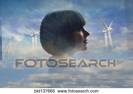Stock Photography - Double exposure of businesswoman and wind turbines in clouds. Fotosearch
