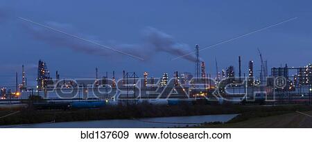 Factory near lake illuminated at night View Large Photo Image Stock Photo - Factory near lake illuminated at night. Fotosearch