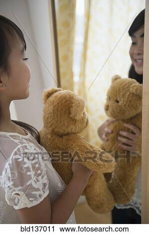 Filipino girl admiring teddy bear in mirror View Large Photo Image Stock Image - Filipino girl admiring teddy bear in mirror. Fotosearch
