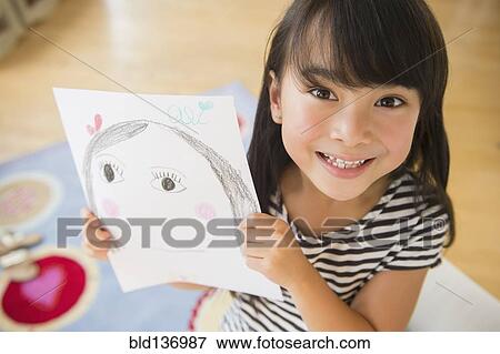 Filipino girl displaying drawing in bedroom View Large Photo Image Stock Photo - Filipino girl displaying drawing in bedroom. Fotosearch
