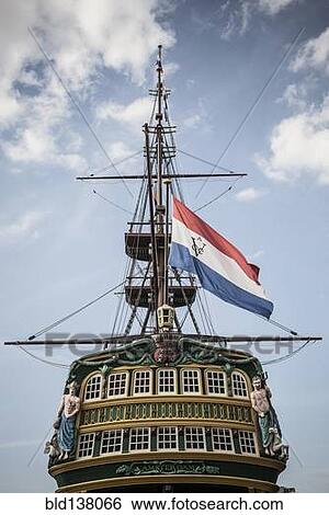 Flag flying from pirate ship against blue sky View Large Photo Image Stock Photograph - Flag flying from pirate ship against blue sky. Fotosearch