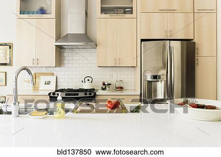 Stock Image - Food and cooking implements on kitchen counter. Fotosearch