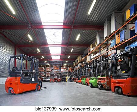 Stock Photo - Forklift machinery in a row in warehouse. Fotosearch