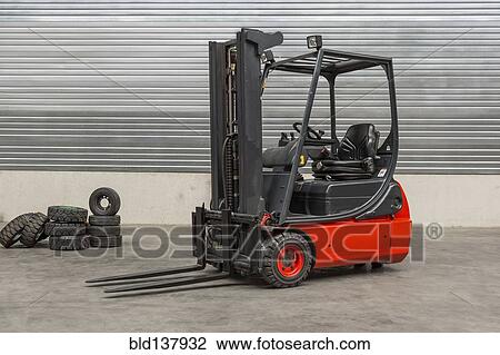 Stock Image - Forklift machinery parked in warehouse. Fotosearch