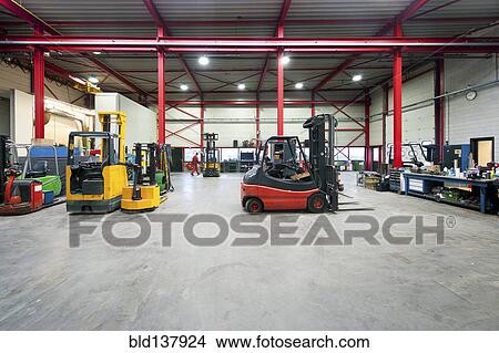 Picture - Forklift machinery working in warehouse. Fotosearch
