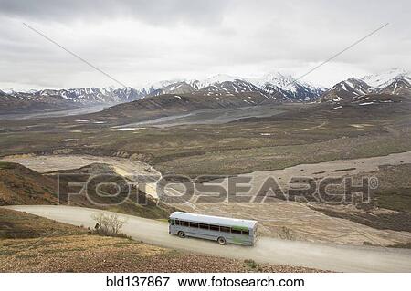 Stock Photo - High angle view of tour bus in rural landscape, Anchorage, Alaska, Denali National Park, United States. Fotosearch