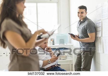Hispanic business people using technology in office View Large Photo Image Stock Image - Hispanic business people using technology in office. Fotosearch