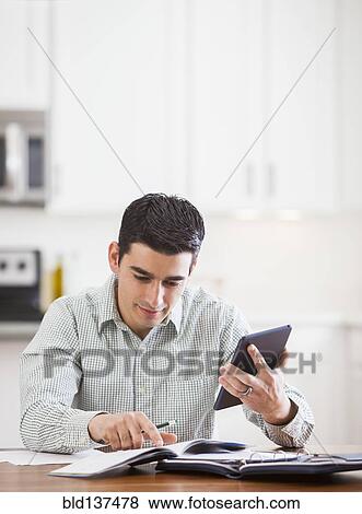 Stock Photo - Hispanic businessman working at home. Fotosearch