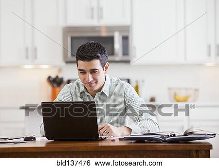 Stock Photograph - Hispanic businessman working at home. Fotosearch